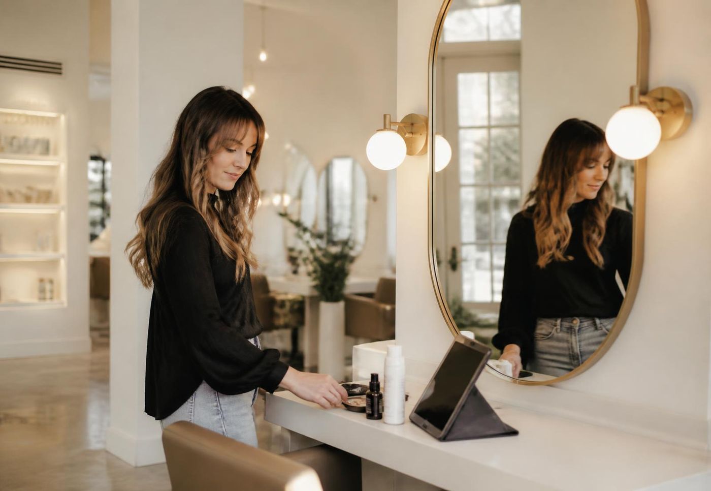 Provider at a salon station reviewing the day's appointments on a tablet